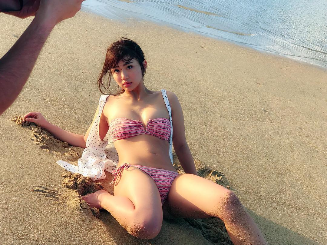 砂浜に横たわるピンクのビキニ水着の平嶋夏海